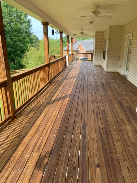 Restored and stained wraparound wood porch on a Middle Tennessee home