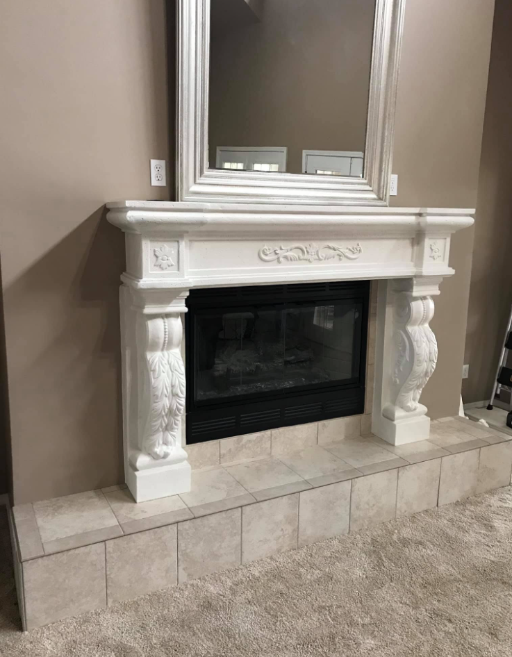 White carved fireplace mantel with new tile hearth and surround